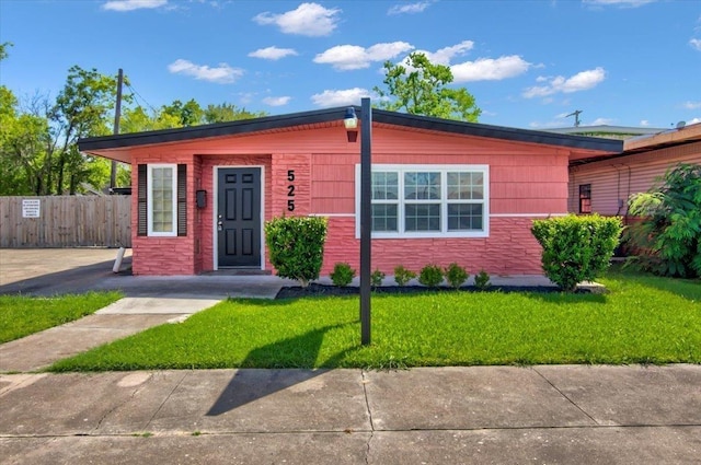 bungalow-style house with a front yard and fence