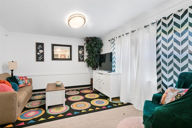 living area featuring wood finished floors and crown molding