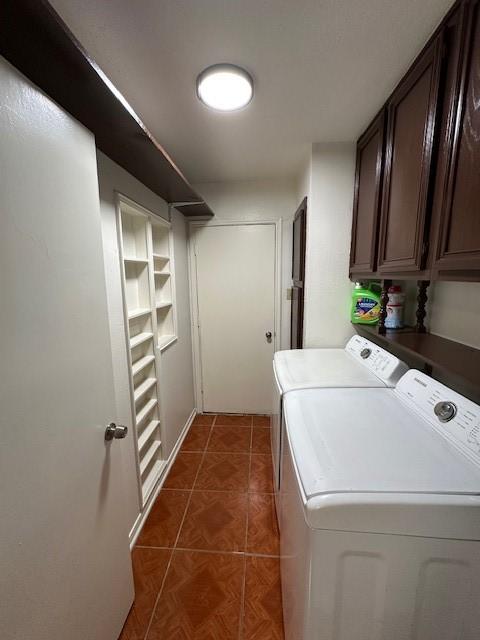 washroom with cabinet space, washer and dryer, and tile patterned floors