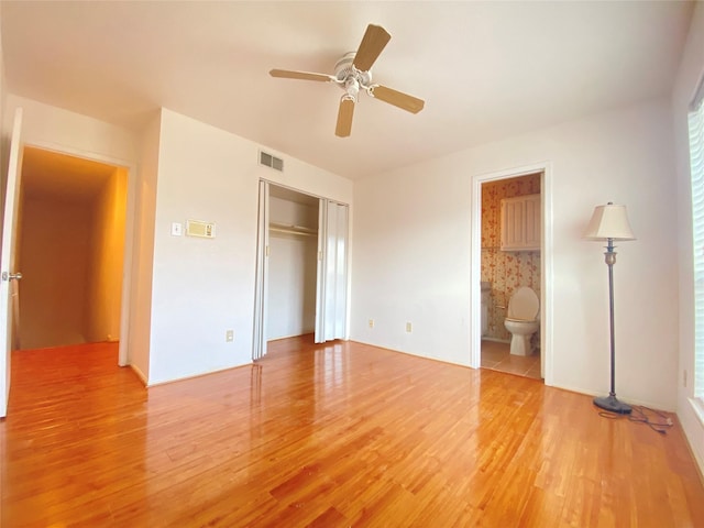 unfurnished bedroom with a ceiling fan, light wood-type flooring, a closet, and visible vents