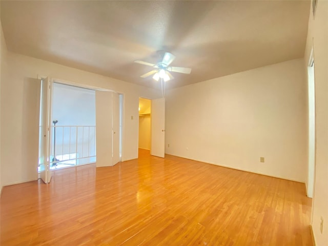 empty room featuring ceiling fan and light wood finished floors