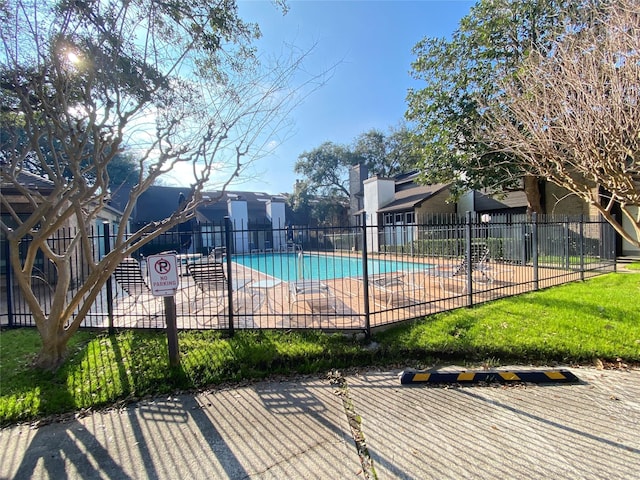 community pool featuring a patio area and fence