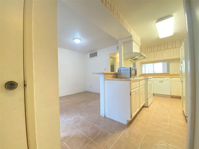 kitchen featuring white appliances, light tile patterned floors, and visible vents