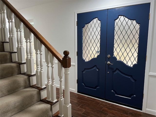 foyer entrance featuring stairs, french doors, dark wood-style flooring, and baseboards