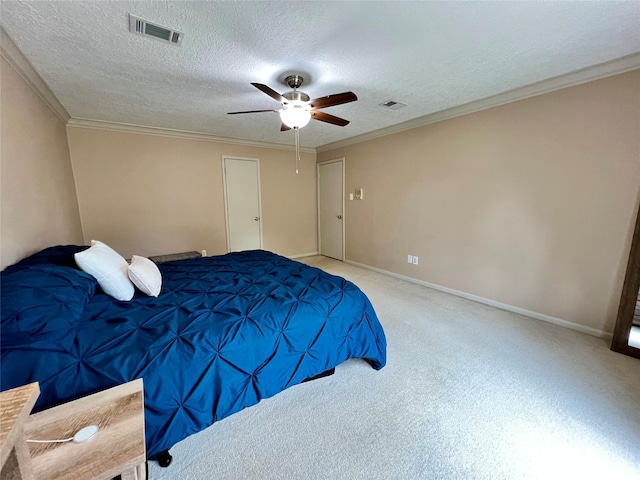 carpeted bedroom with visible vents, a textured ceiling, ceiling fan, and crown molding