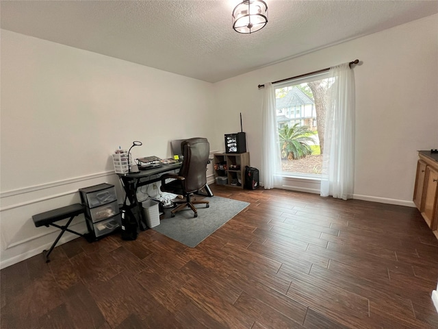 home office featuring a textured ceiling and dark wood-style flooring