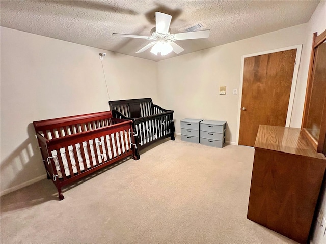 bedroom featuring visible vents, a textured ceiling, and carpet floors