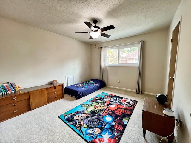 bedroom featuring baseboards, a ceiling fan, carpet flooring, and a textured ceiling