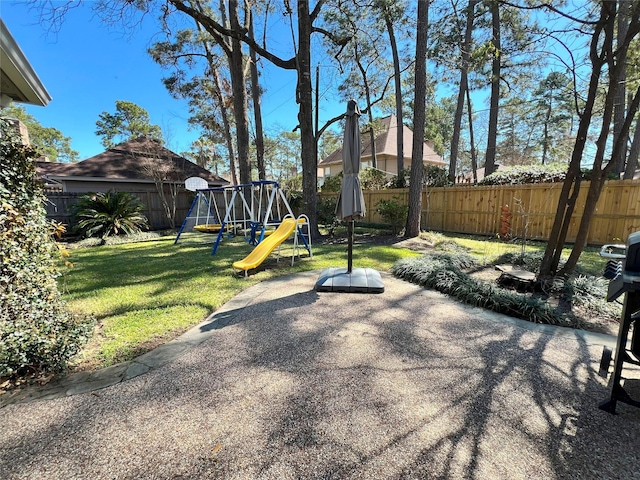 exterior space featuring a playground and a fenced backyard