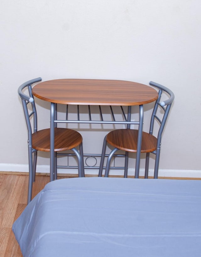 interior space featuring wood finished floors and baseboards