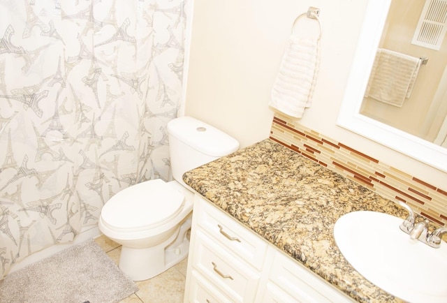 bathroom with toilet, vanity, visible vents, and tile patterned floors