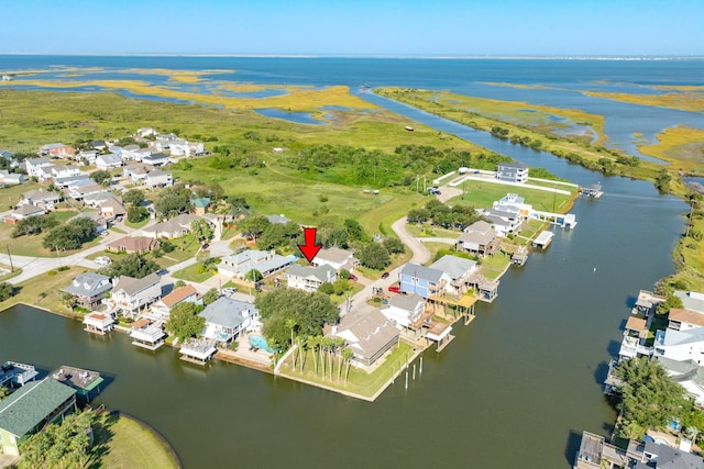 drone / aerial view featuring a residential view and a water view