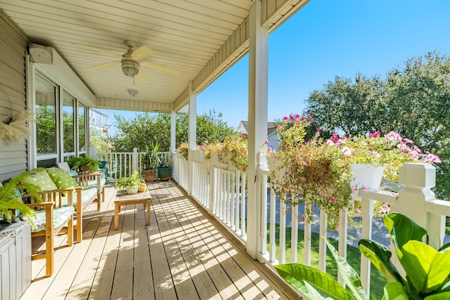 wooden terrace featuring ceiling fan