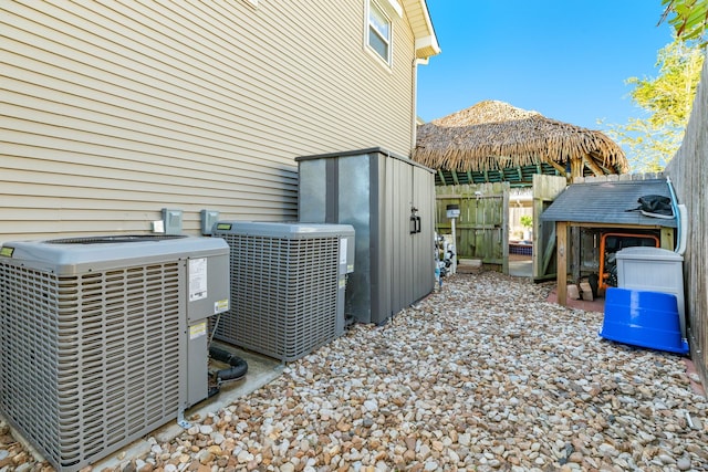 exterior space featuring cooling unit and fence