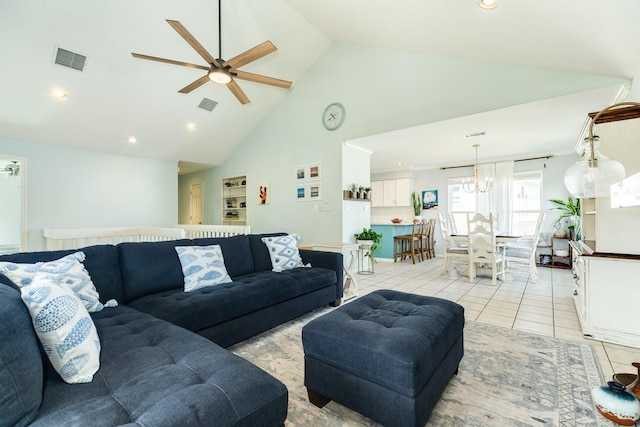 living area featuring light tile patterned floors, ceiling fan, visible vents, and high vaulted ceiling