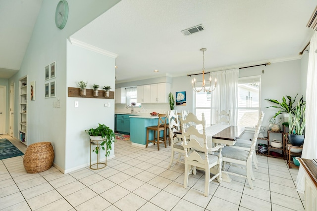 dining room featuring a healthy amount of sunlight, visible vents, and ornamental molding