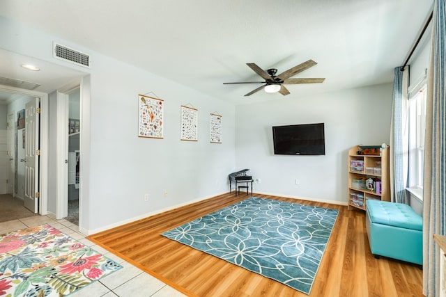 interior space featuring visible vents, ceiling fan, baseboards, and wood finished floors