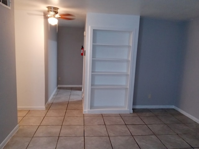5625 Antoine Dr Unit 413, Houston, TX 77091 - unfurnished room featuring baseboards, visible vents, a ceiling fan, built in features, and light tile patterned flooring