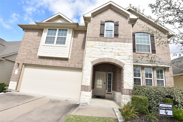 view of front of property with stone siding, concrete driveway, brick siding, and an attached garage