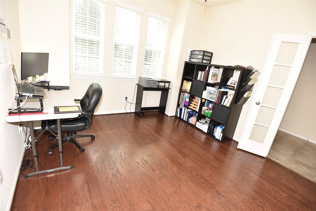 office space featuring baseboards and wood finished floors