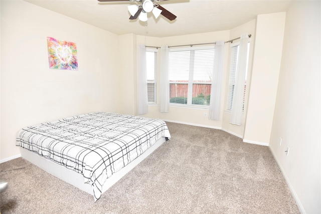 bedroom with carpet flooring, ceiling fan, and baseboards