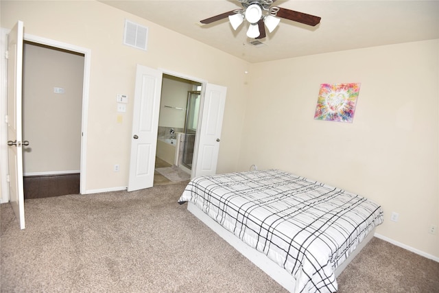 bedroom featuring ensuite bathroom, carpet, visible vents, and baseboards