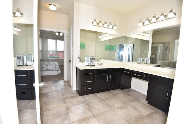 full bathroom featuring a stall shower, vanity, ensuite bath, and tile patterned floors