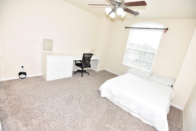 bedroom with a ceiling fan, baseboards, and carpet flooring