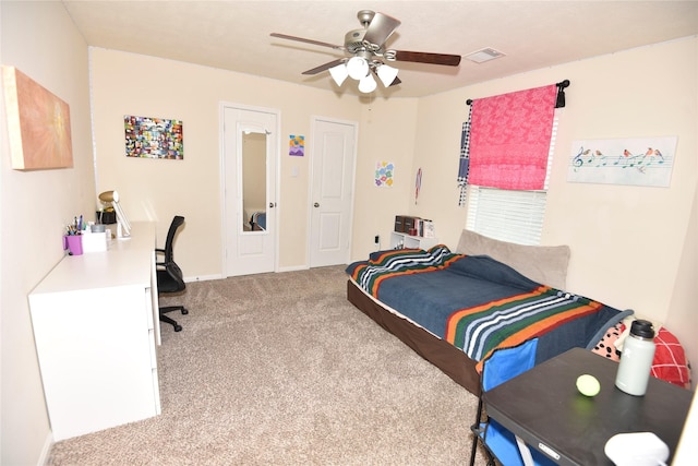 carpeted bedroom featuring visible vents and ceiling fan