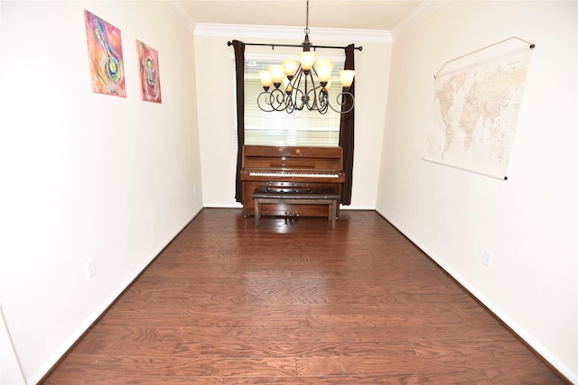 unfurnished dining area featuring dark wood finished floors, a notable chandelier, crown molding, and baseboards