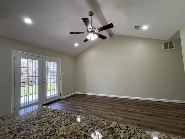 unfurnished room with dark wood-type flooring, french doors, visible vents, and lofted ceiling with beams