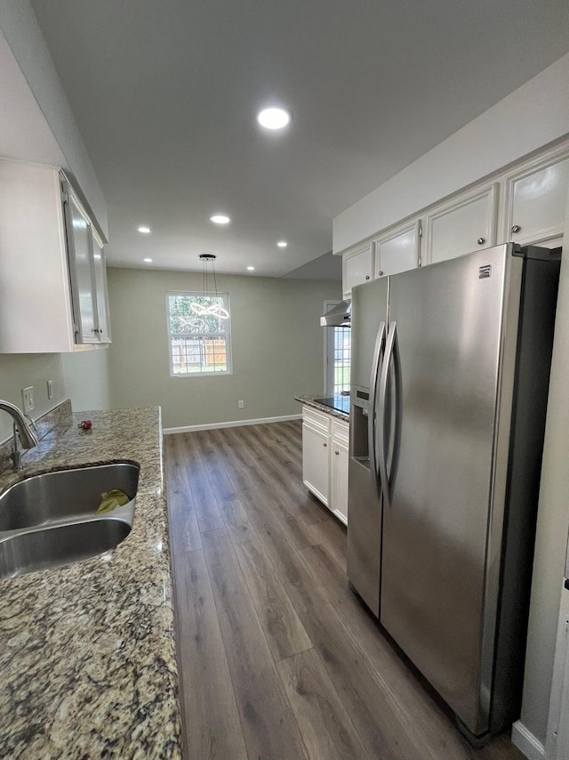 kitchen featuring dark wood-type flooring, ventilation hood, white cabinetry, stainless steel refrigerator with ice dispenser, and a sink