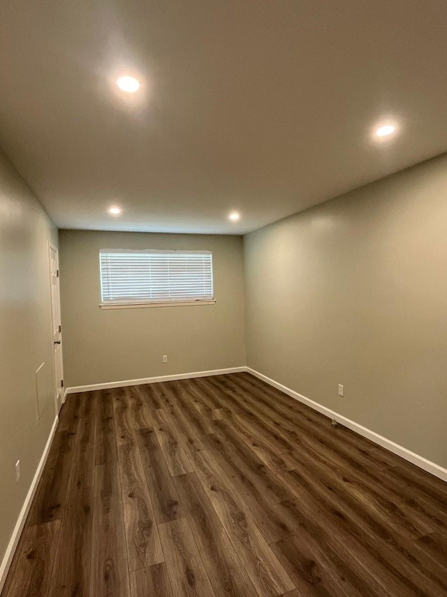 empty room featuring dark wood-style floors, baseboards, and recessed lighting