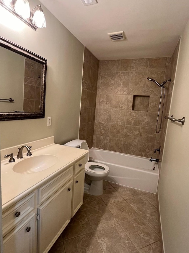 bathroom with visible vents, toilet, vanity, shower / tub combination, and baseboards