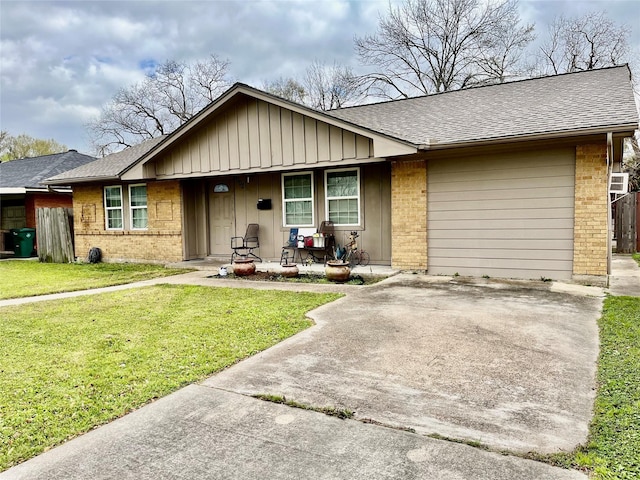 single story home featuring brick siding, a shingled roof, an attached garage, driveway, and a front lawn