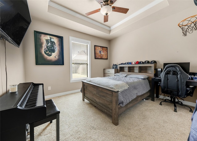 bedroom featuring baseboards, a tray ceiling, light colored carpet, and ornamental molding