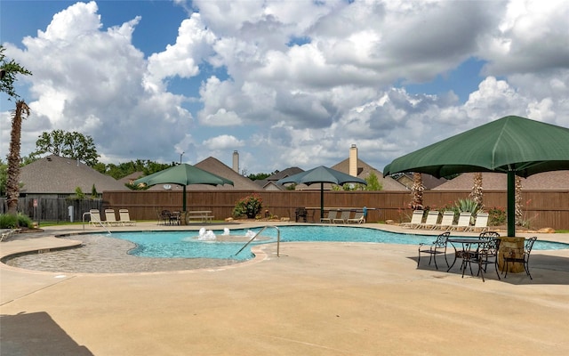 pool with a patio and fence