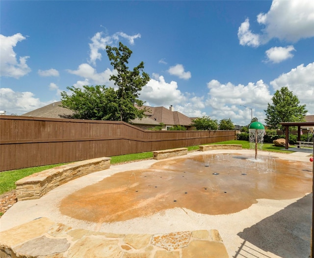 view of swimming pool with a fenced backyard and a patio