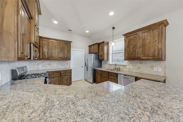 kitchen with stainless steel appliances, visible vents, a sink, and backsplash