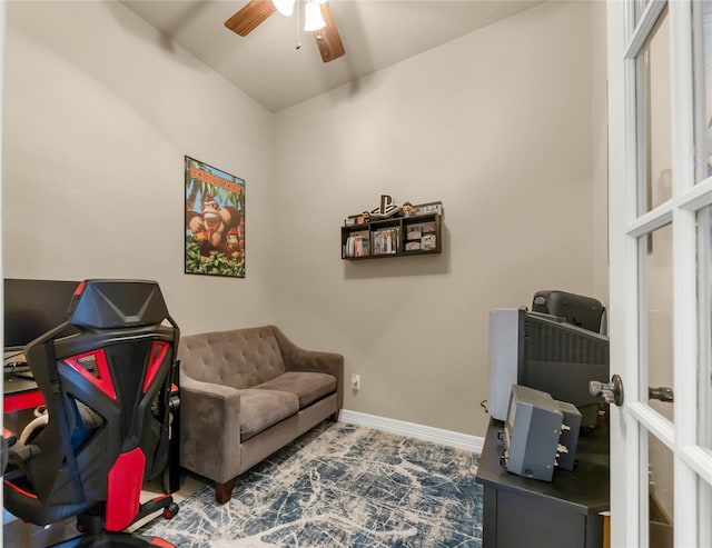 interior space featuring a ceiling fan and baseboards