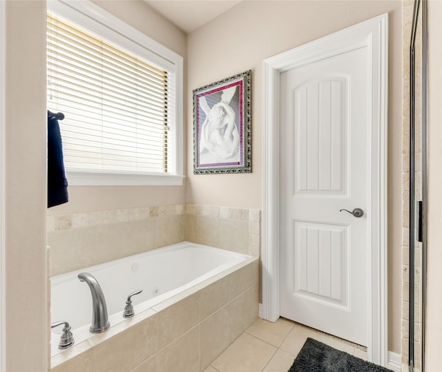 full bath with tile patterned flooring and a whirlpool tub