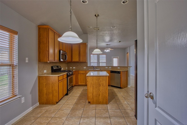 kitchen featuring light countertops, appliances with stainless steel finishes, light tile patterned flooring, and a sink