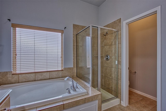 full bathroom featuring a garden tub, tile patterned flooring, a shower stall, and toilet