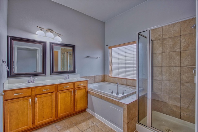 full bath featuring a garden tub, a stall shower, and a sink