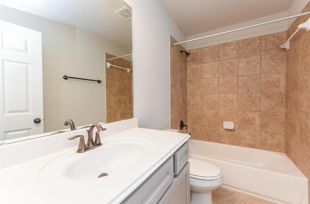 bathroom with bathtub / shower combination, toilet, vanity, visible vents, and tile patterned floors