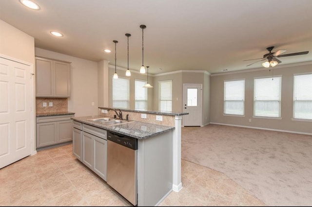 kitchen with light colored carpet, gray cabinetry, stainless steel dishwasher, open floor plan, and a sink