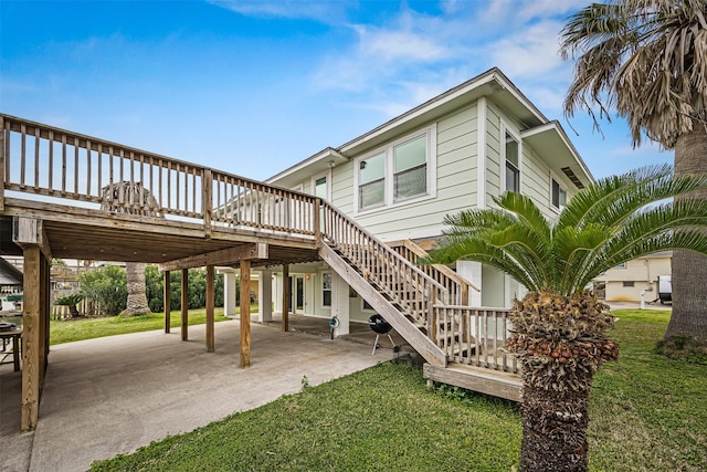 back of property with a patio area, stairway, a lawn, and a wooden deck