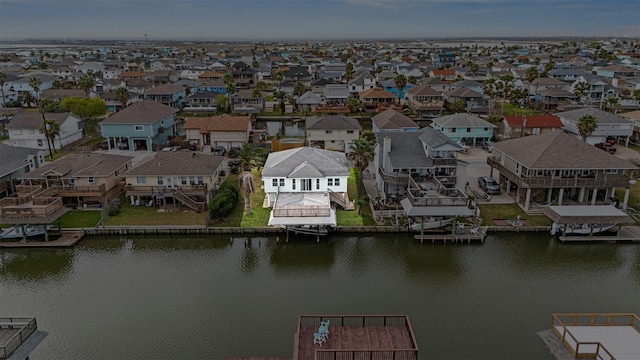 drone / aerial view with a residential view and a water view