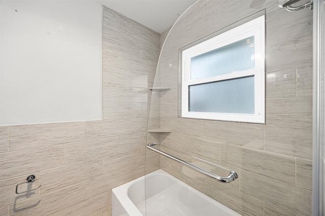 bathroom featuring tile walls and shower / bath combination