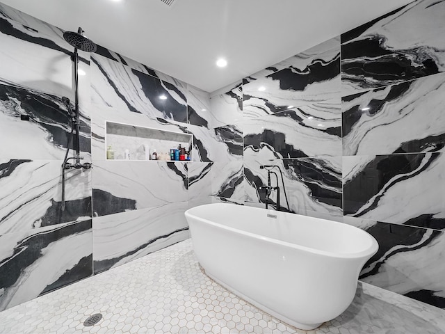 bathroom with walk in shower, a soaking tub, stone wall, and recessed lighting